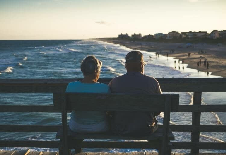 Senior couple sitting on a bench together 